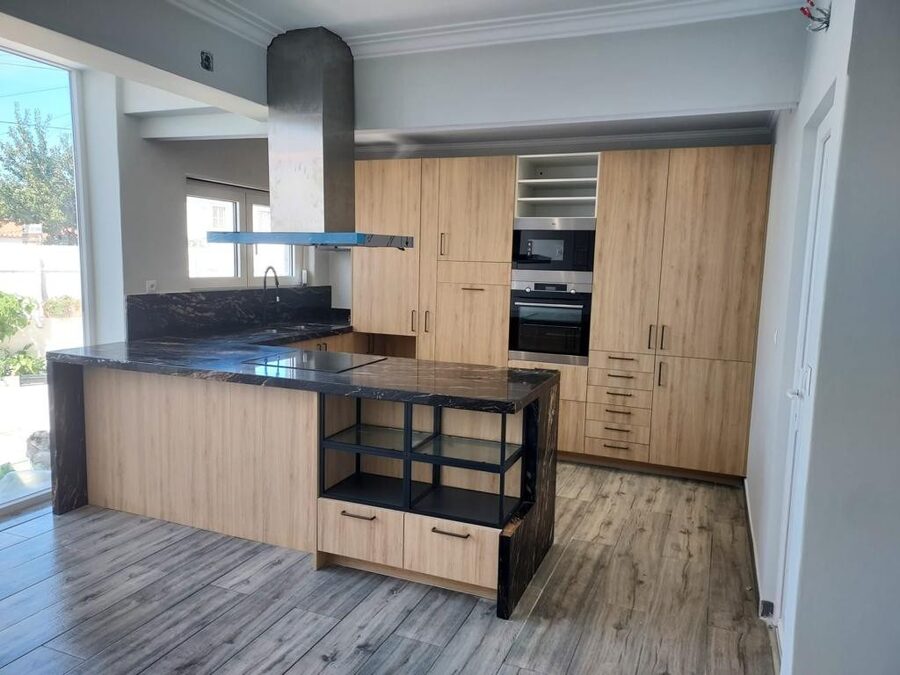 Remodeled kitchen with stone countertop and island